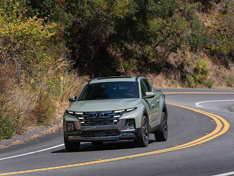 Grey Hyundai Santa Cruz driving on canyon road